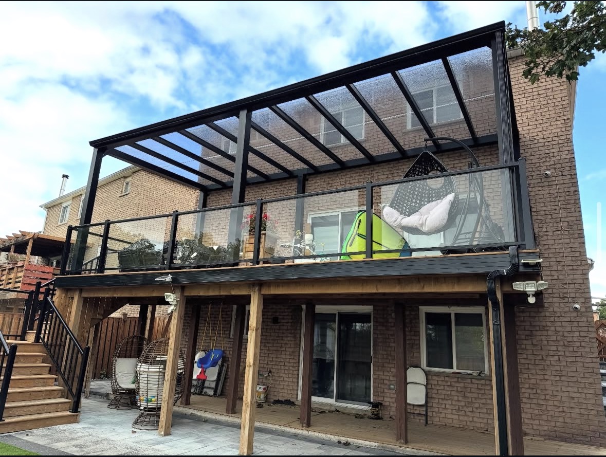 Elevated deck sunroom with glass railing